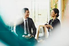 A photo of a woman working as an executive assistant with her immediate male supervisor