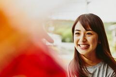 A smiling woman looking to the left