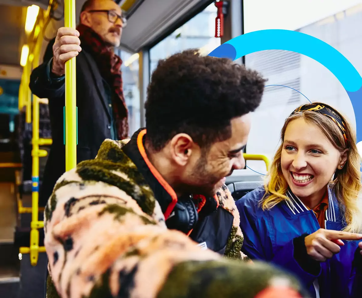 an image of a man and woman smiling at each other while inside a bus